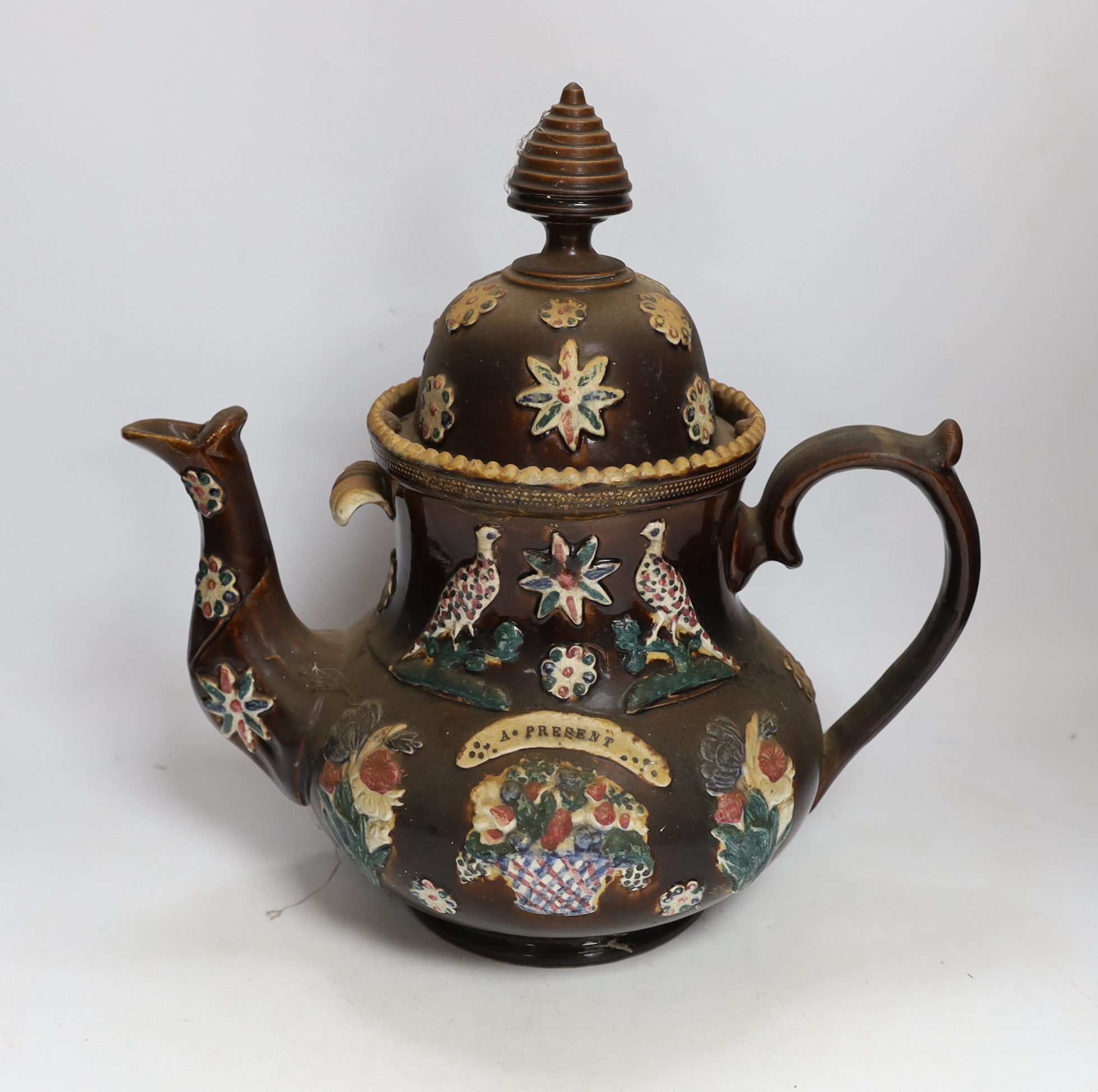 A Measham Barge ware glazed pottery teapot, decorated in relief, 35cm wide